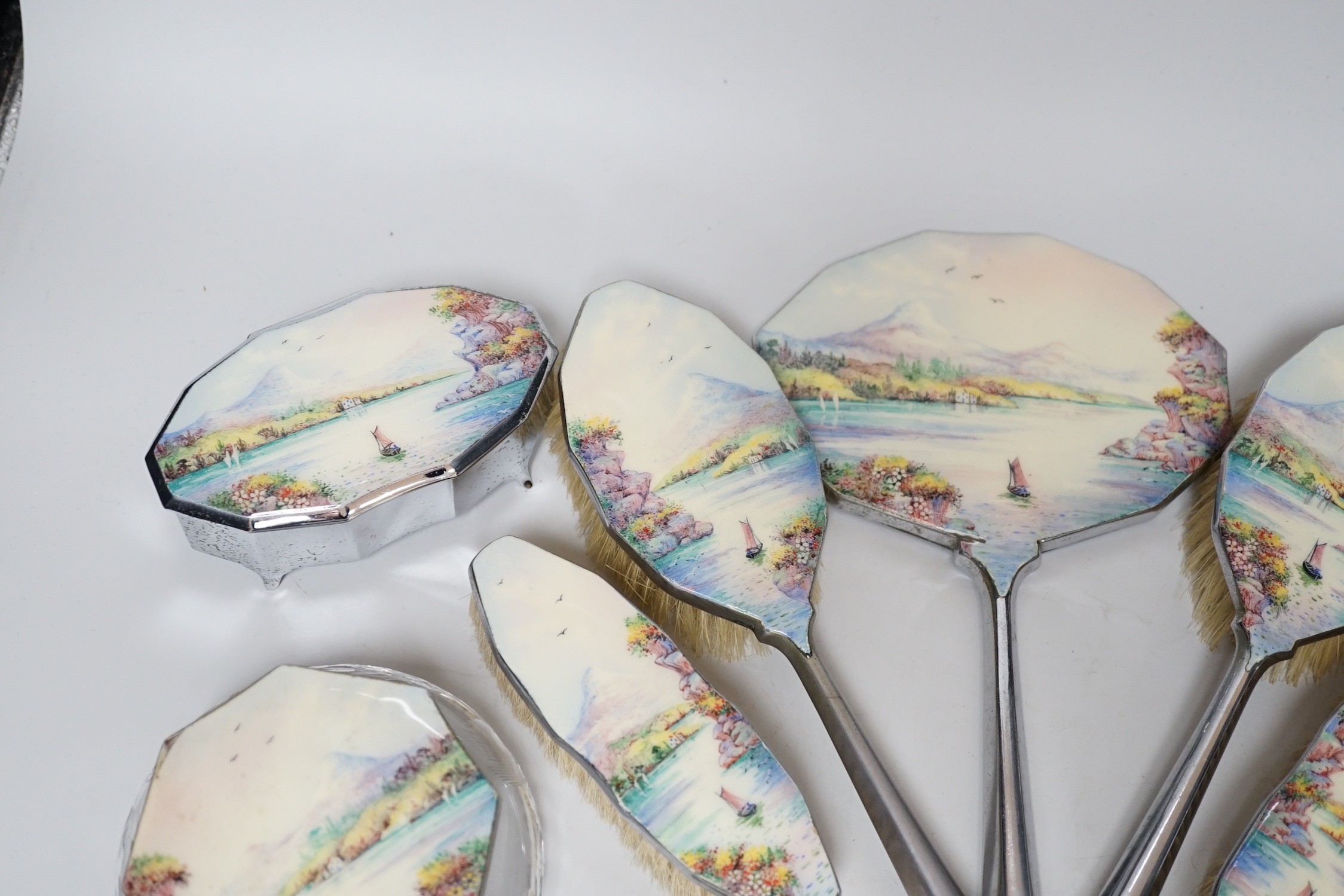 A twelve piece chrome plated and enamel dressing table set